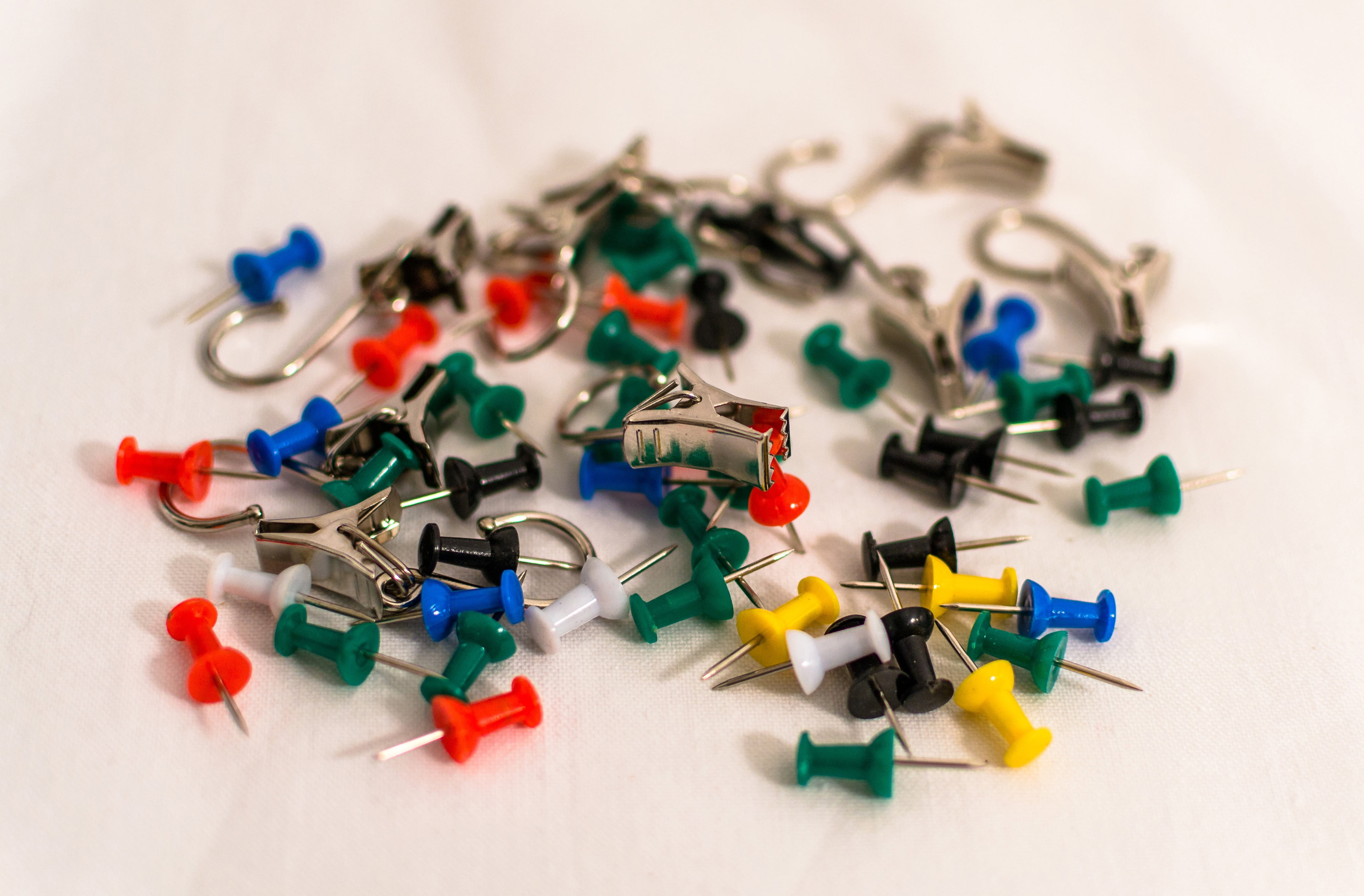 clamp, directly above, metal, close, silver, selective focus, white background, black, green color, pointed, shiny, 4K, close-up, colorful, needles, abundance, HD Wallpaper