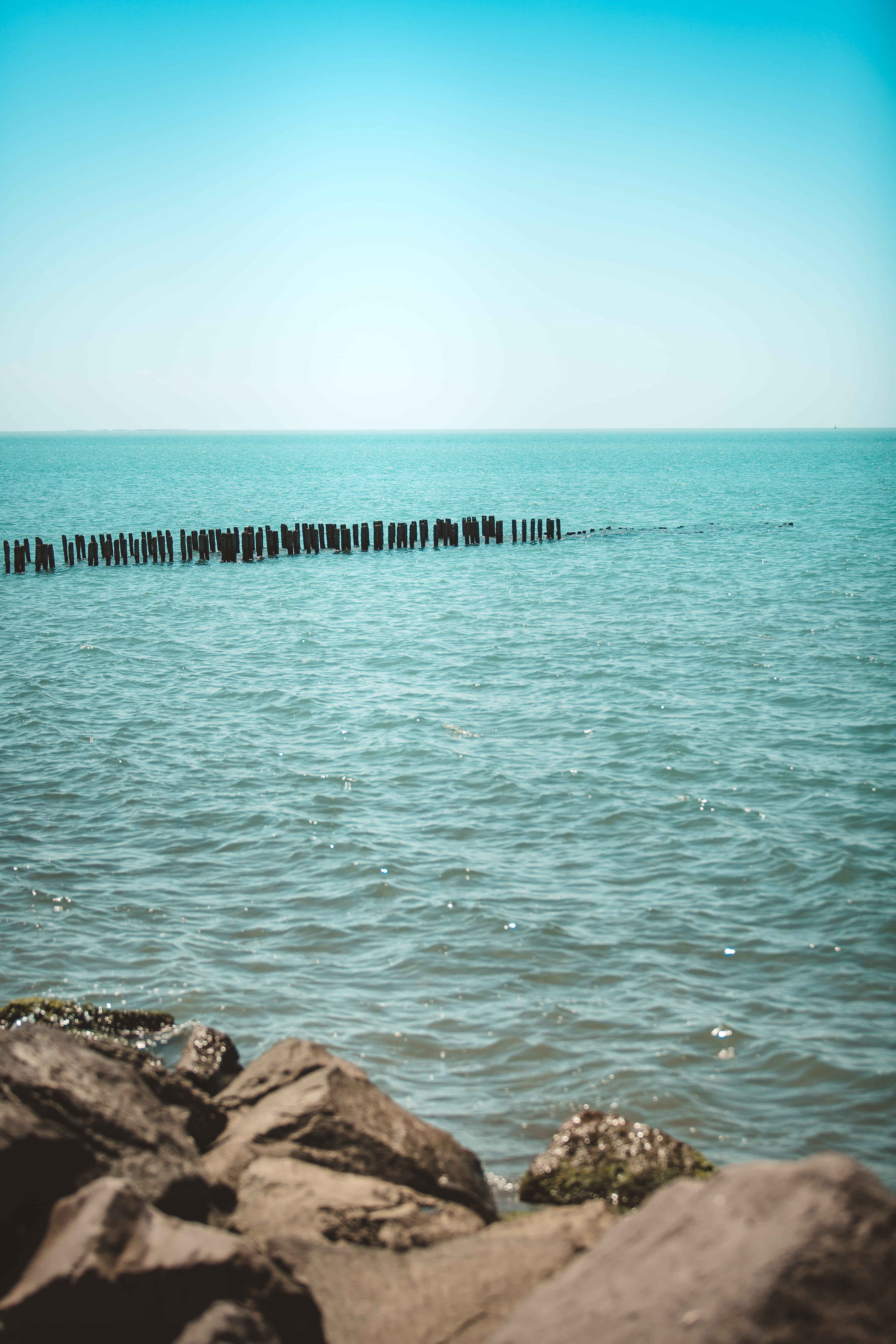 non-urban scene, dock, day, lake, wood, blue, coast, outdoors, sky, beauty in nature, horizon, ocean, port, groyne, gray, back, poti, no people, tranquil scene, Phone HD Wallpaper