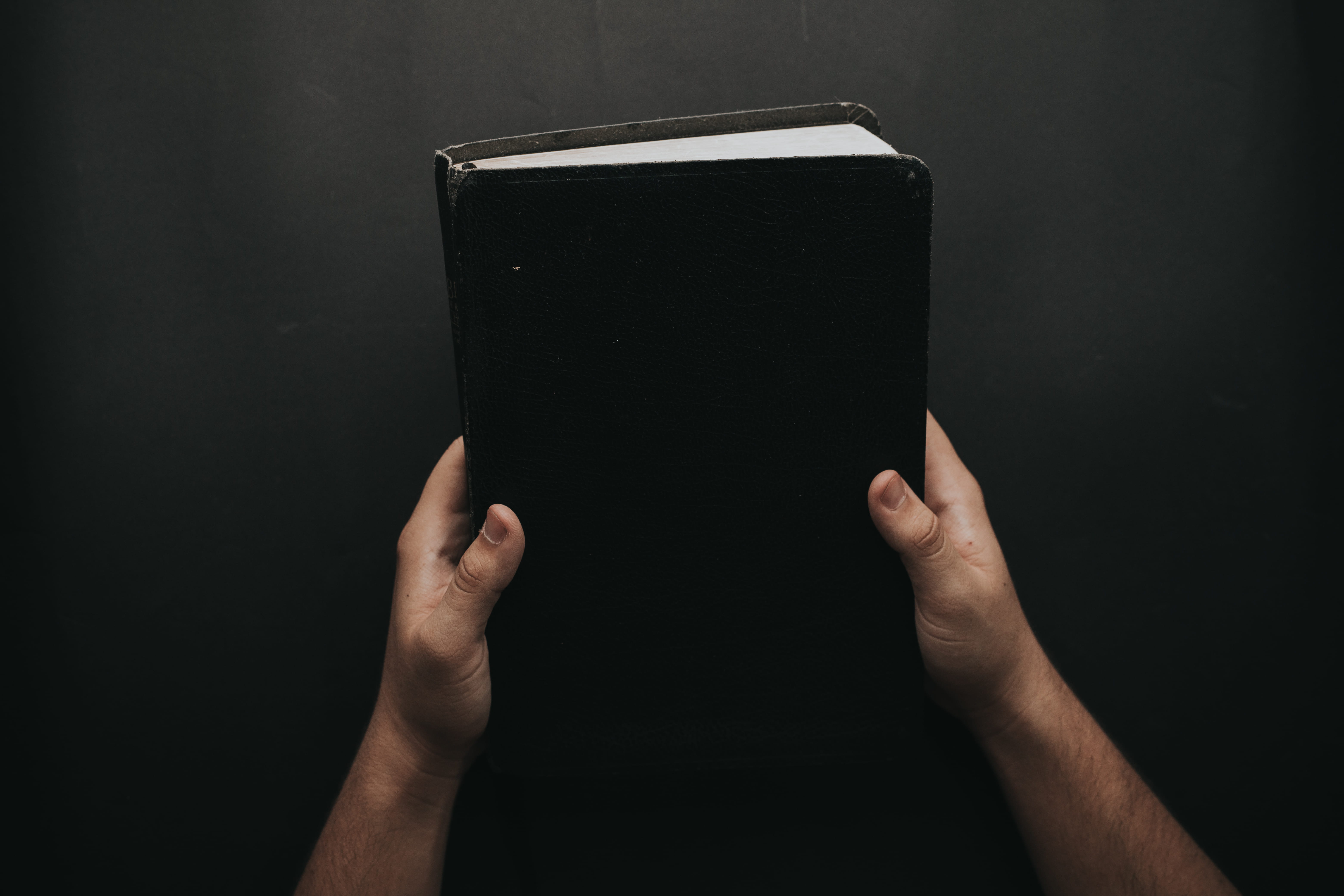 bible, book, one person, wireless technology, person, human hand, lifestyles, single object, 5K, black, cover, studio shot, human body part, portable information device, HD Wallpaper