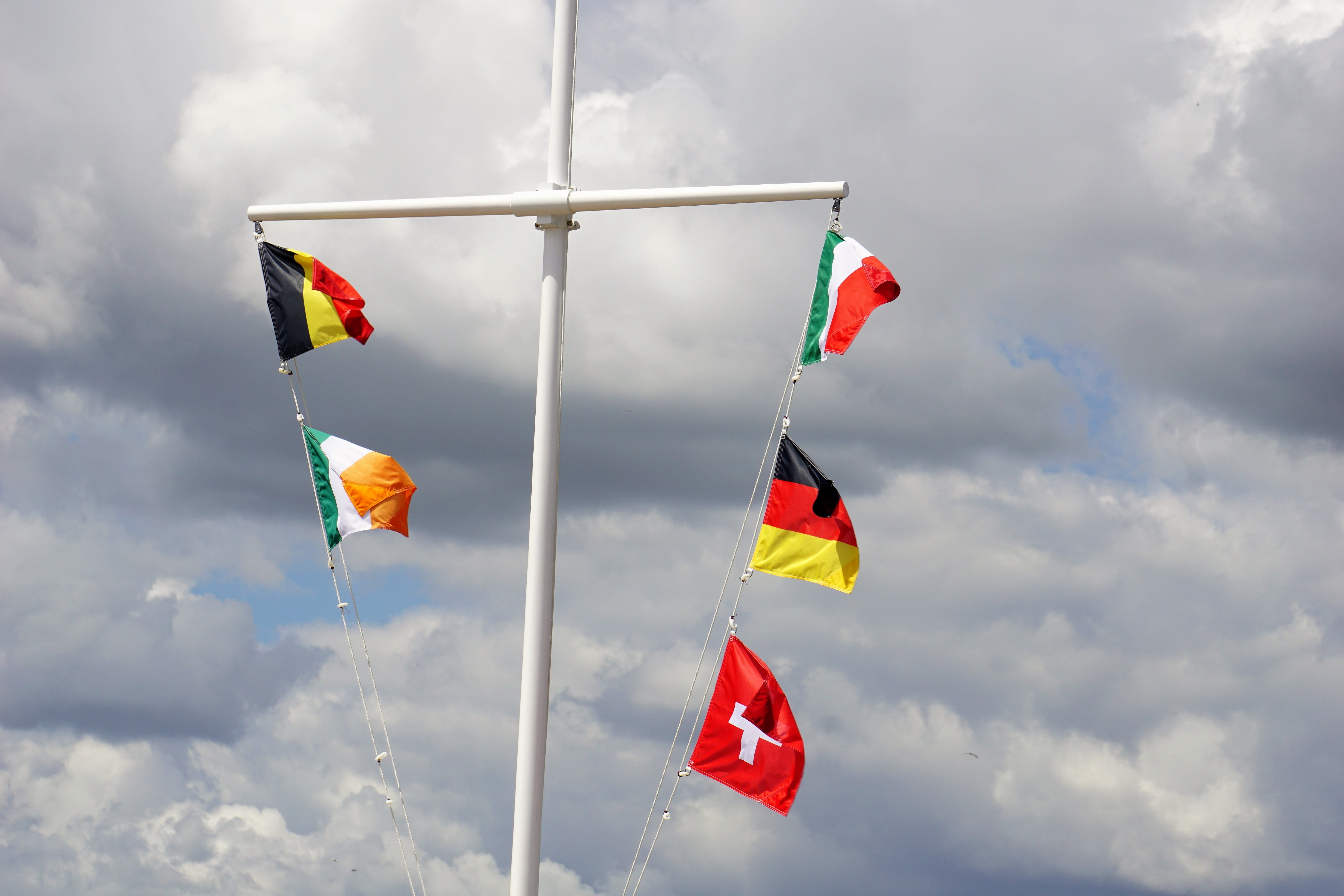 nature, no people, side by side, pole, 5K, red, shape, mat, low angle view, wind, cloud - sky, outdoors, environment, multi colored, day, flag, sky, flags, HD Wallpaper