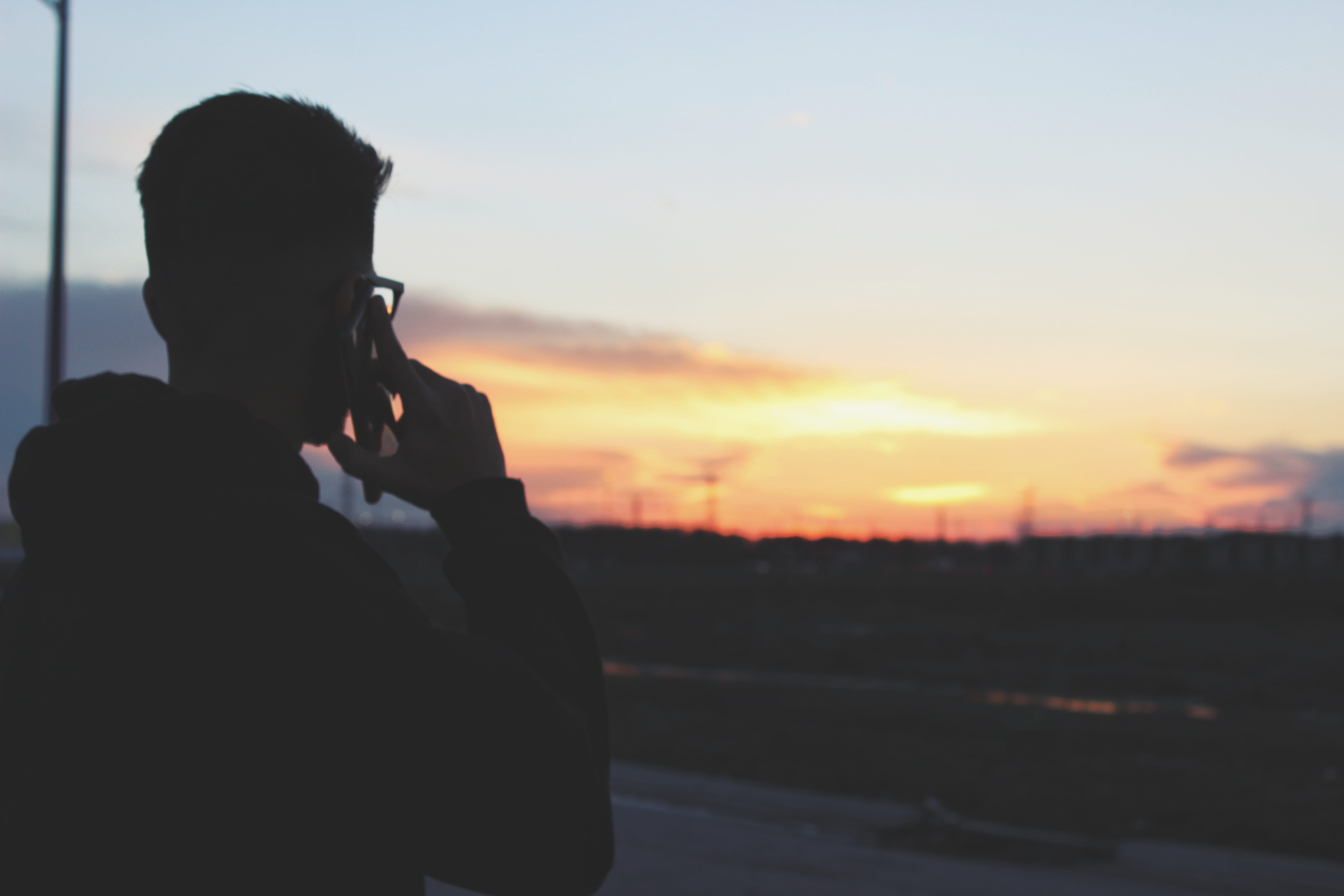 daytime, silhouette, male, communication, wireless technology, photography themes, real people, near, holding, lifestyles, man, men, mobile phone, telephone, HD Wallpaper