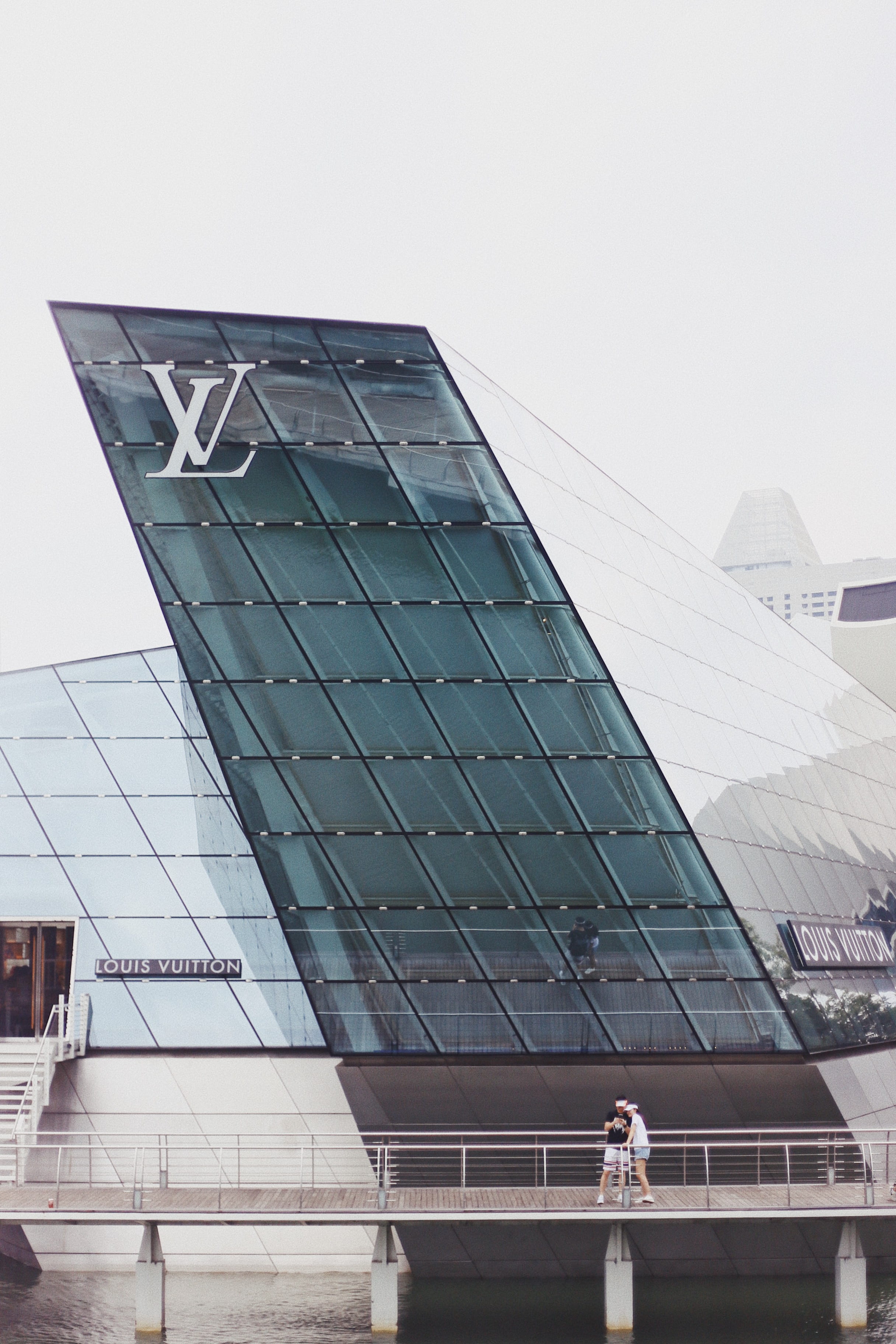 outdoors, city, 2K, low angle view, sky, bridge, clear sky, louis, day, outdoor, standing, people, modern, building, near, reflection, vuitton, two, glass - material, Phone HD Wallpaper