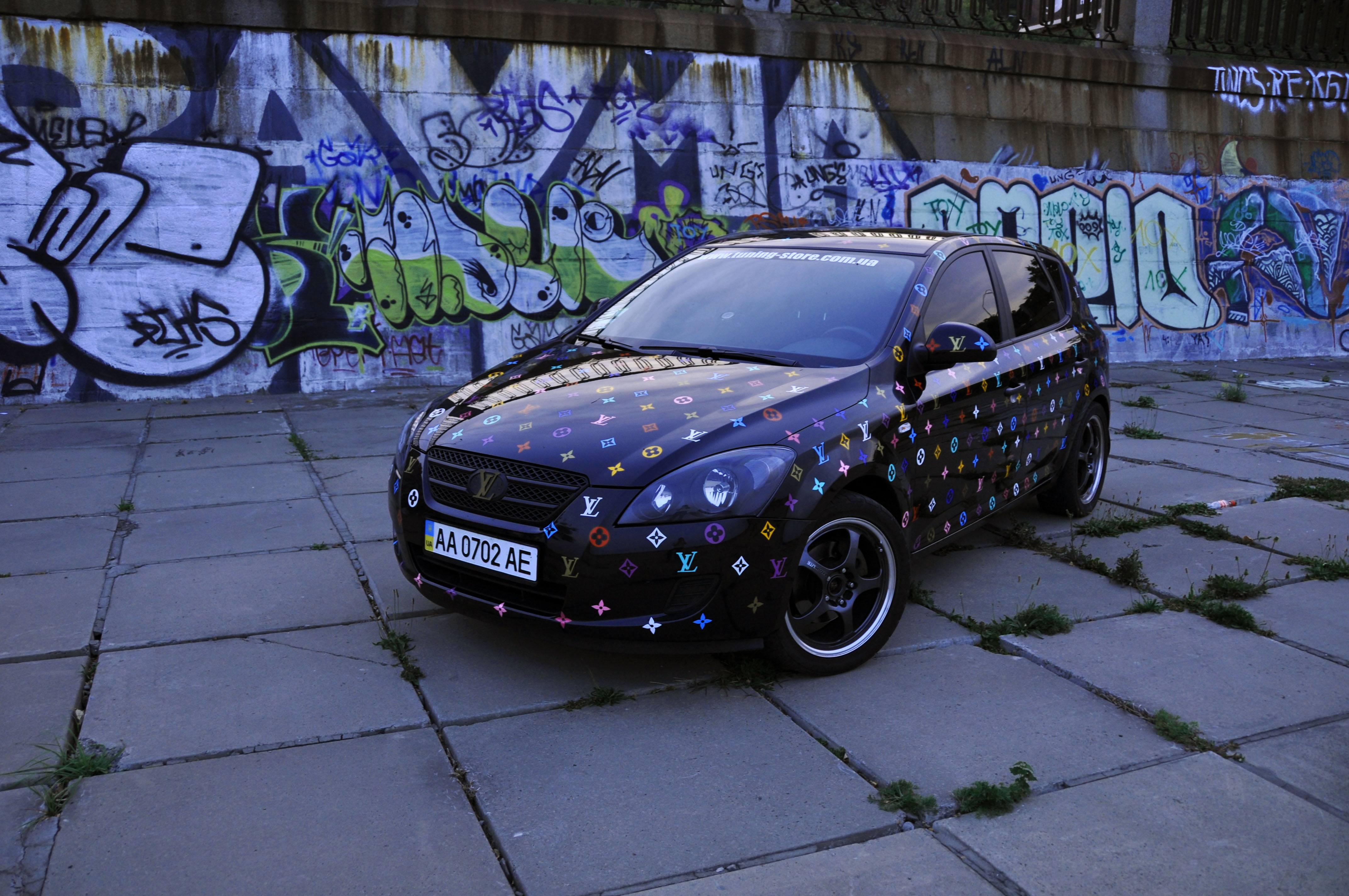 transportation, exhibition, black, city, Graffiti, built structure, footpath, speed, hatchback, shiny, garage, paving stone, architecture, plant, outdoors, HD Wallpaper