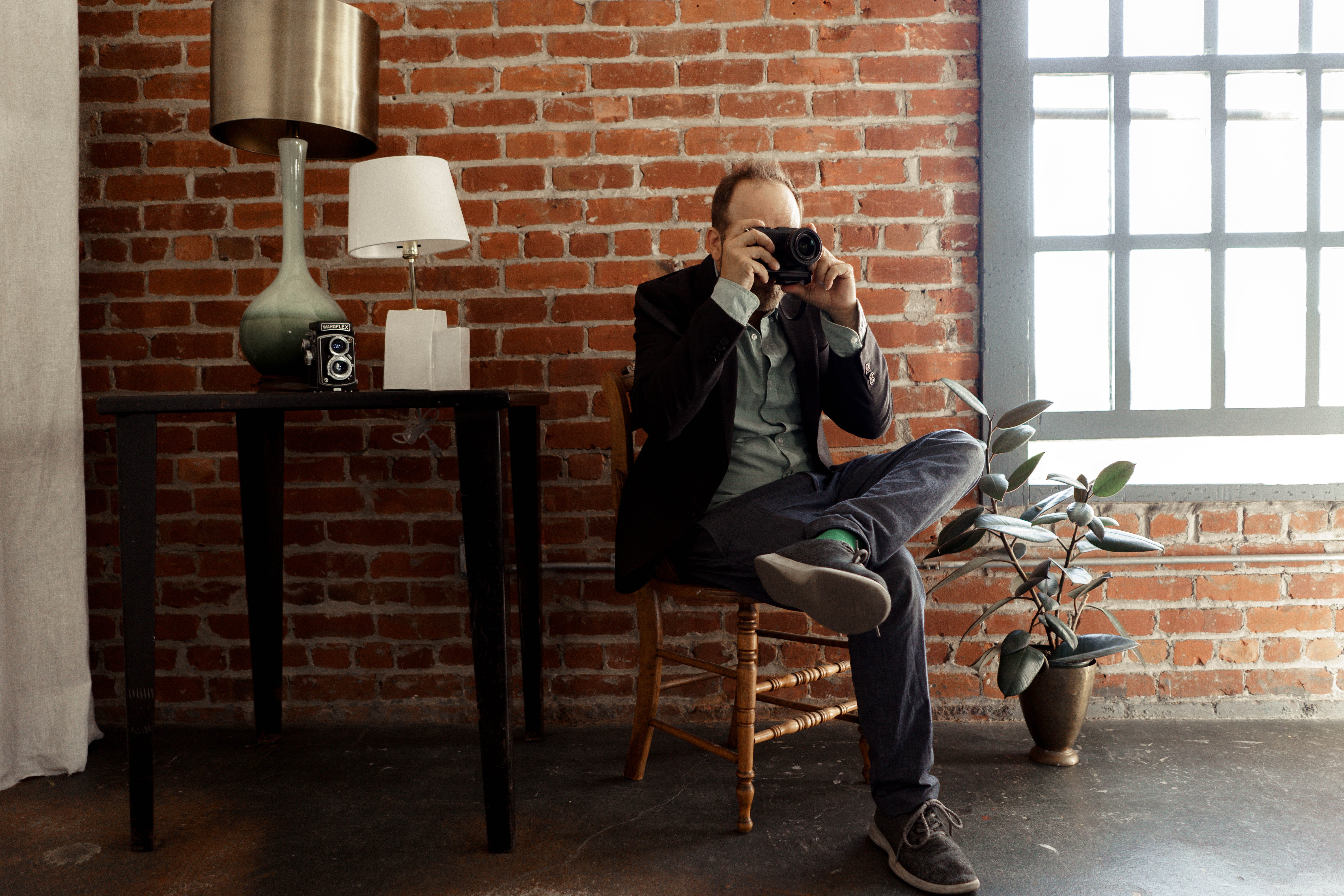 united states, wall, communication, studio, man, sitting, photographer, brick, leisure activity, wall - building feature, real people, chair, young adult, HD Wallpaper