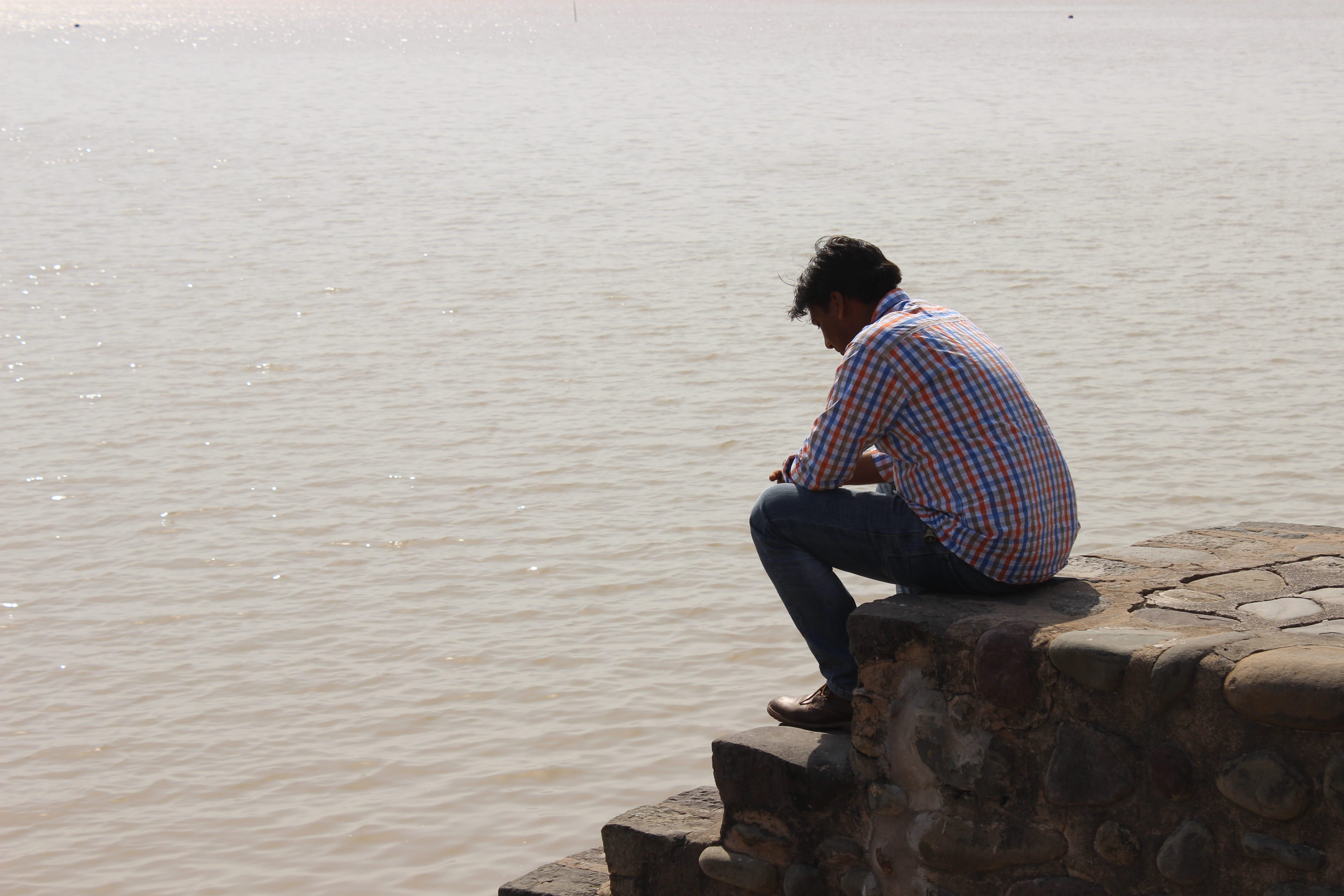 leisure activity, Man, real people, day, shore, male, young men, rock - object, young adult, lifestyles, outdoors, rear view, Water, Chandigarh, men, solid, HD Wallpaper
