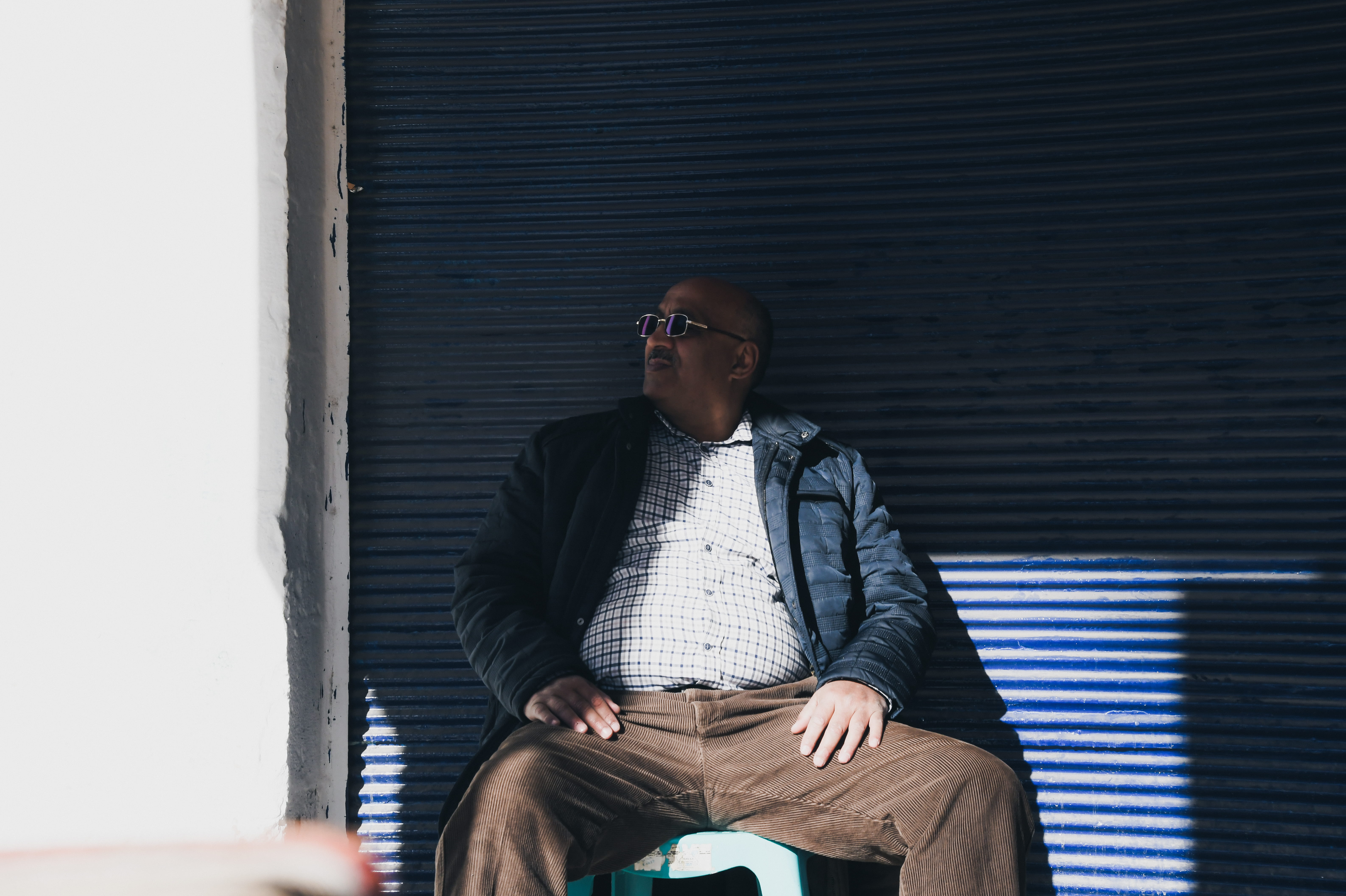 sitting, lifestyles, leisure activity, architecture, shoe, man, home decor, human, wall, young adult, window, overcoat, curtain, black, coat, finger, glasses, HD Wallpaper