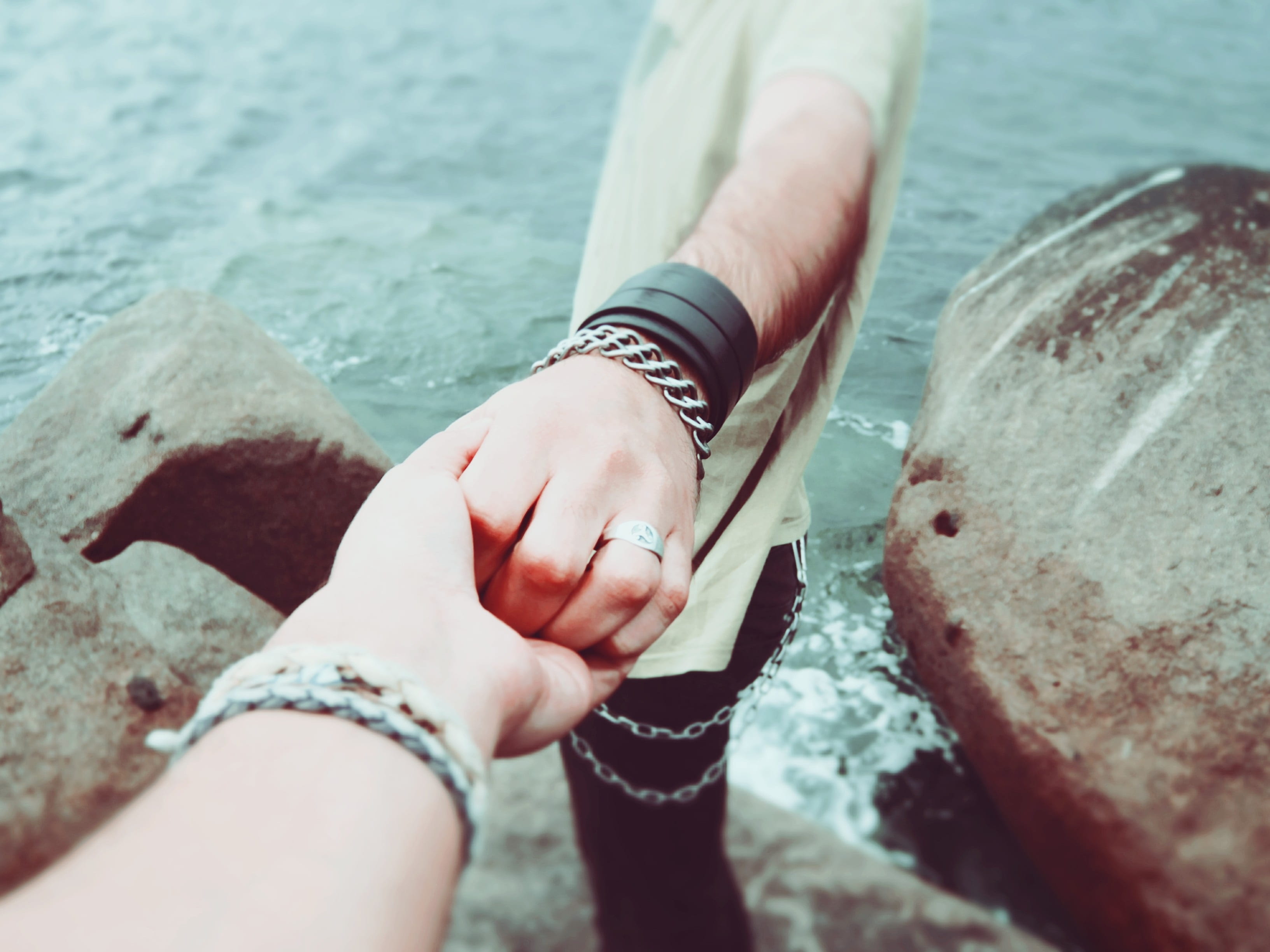 lifestyles, holding hands, human body part, men, rock, outdoors, nature, rocks, two people, bracelet, human hand, leather, couple - relationship, body part, HD Wallpaper