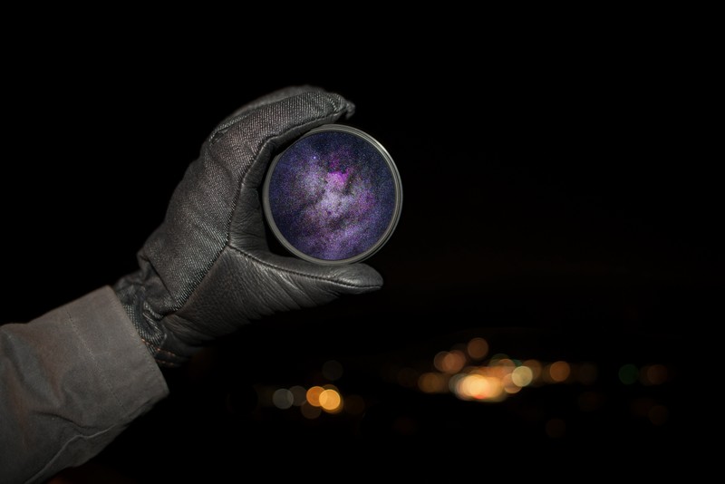 black background, closeup, photography, gloves, bokeh, lens, stars, universe, galaxy, hands, depth of field, night, lights, space