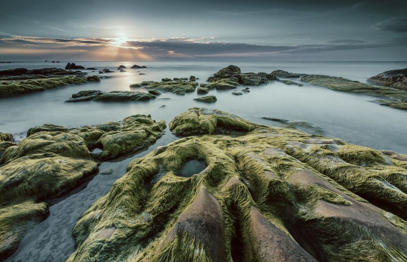 sun rays, clouds, stones, sea