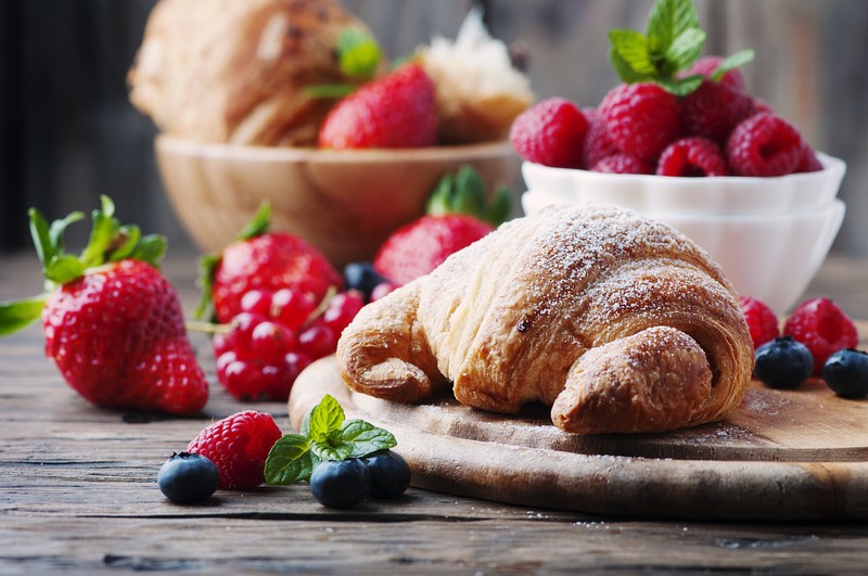 strawberries, blueberries, raspberries, croissants, pastries