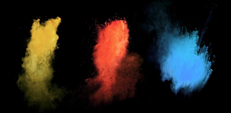 powder explosion, powder, colorful, red, black background, yellow, cyan, blue, black, CMYK
