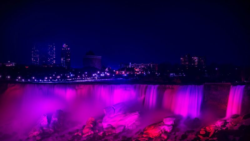 night city, waterfall, lights, stones, architecture, buildings, 4k