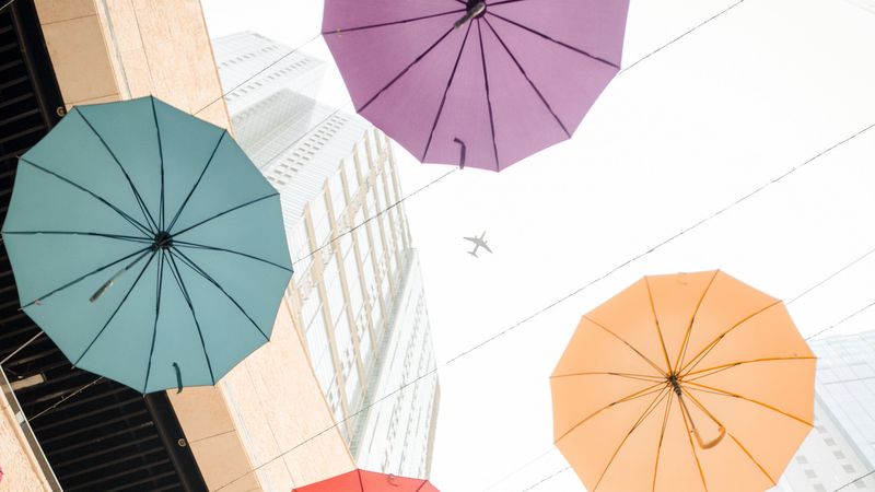 umbrellas, colorful, plane, buildings, 4k