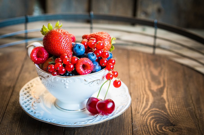 colorful, cup, food, fruit, berries, strawberries, blueberries, red currant, cherries, saucer, wooden surface