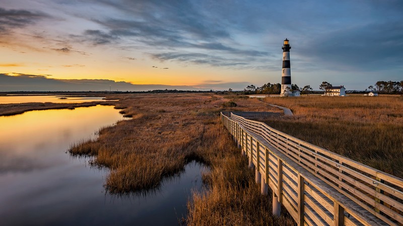nature, landscape, far view, wooden walkway, clouds, sky, sunset, house, lighthouse, water, plants, grass, trees, Bodie Island Lighthouse, North Carolina, USA