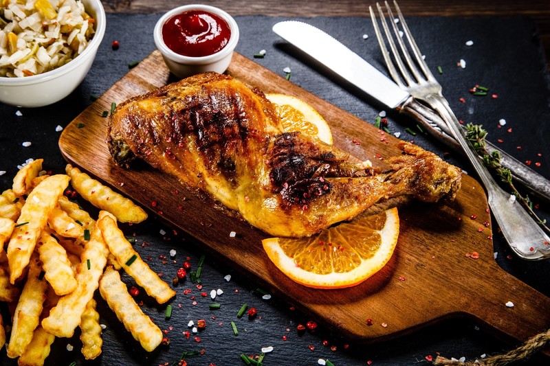 food, meat, Chicken, Fries, birds, legs, animals, death, flesh, muscles, orange (fruit), cutting board, fork, table knife, ketchup