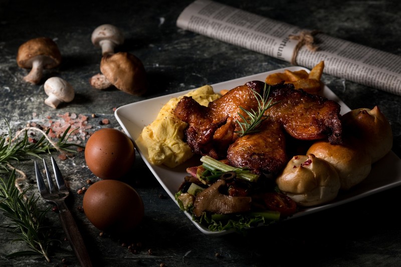 food, meat, eggs, bacon, breakfast, mushroom, bread, rosemary, newspapers, salt, fork