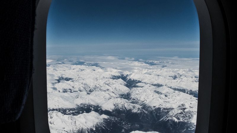 porthole, airplane window, mountains, aerial view, flight, sky, peaks, 4k
