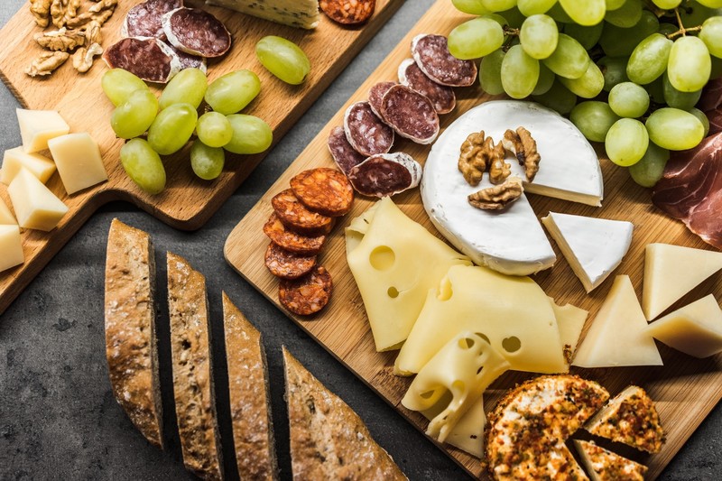 sausage, food, cheese, fruit, grapes, bread, charcuterie board, cutting board, nuts