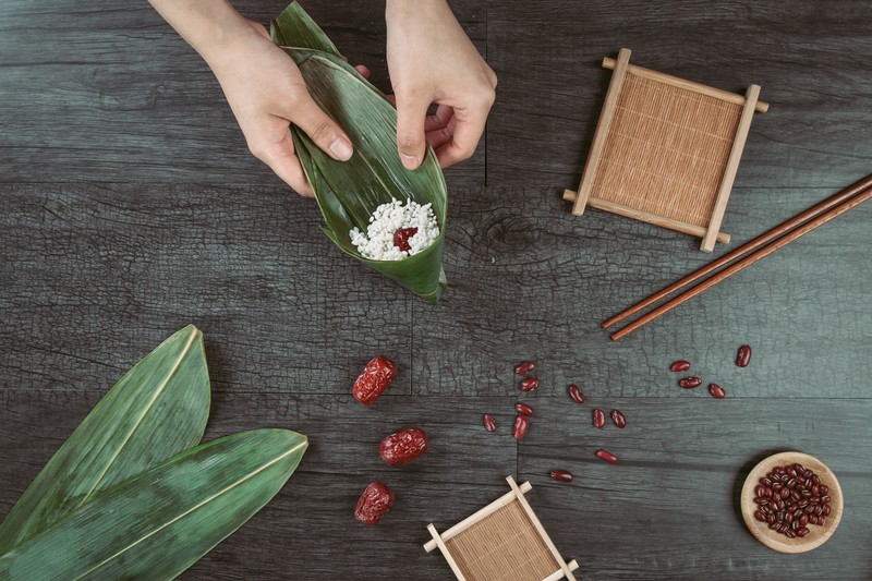 food, rice, leaves, fruit, chopsticks, wooden surface, hands