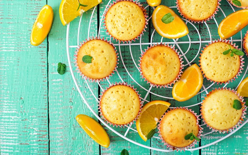 wooden surface, sweets, orange (fruit), food, muffins, mint leaves, lemons, green
