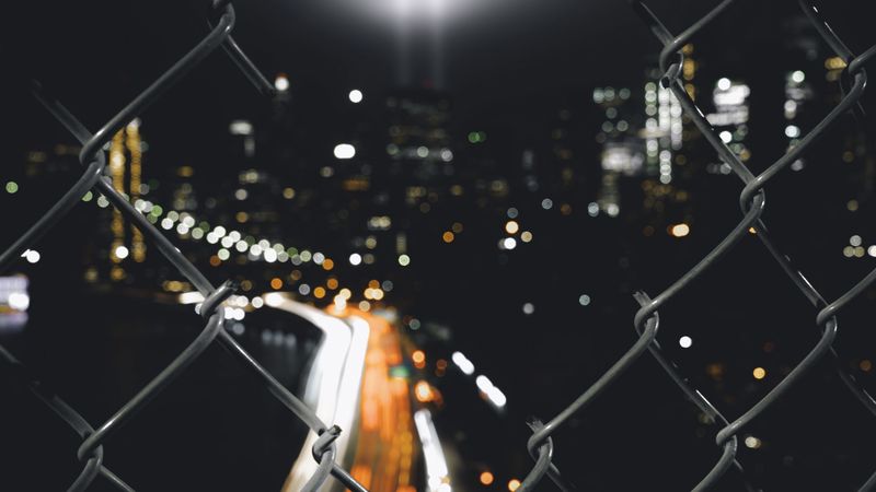 night city, fence, mesh, glare, blur, 4k