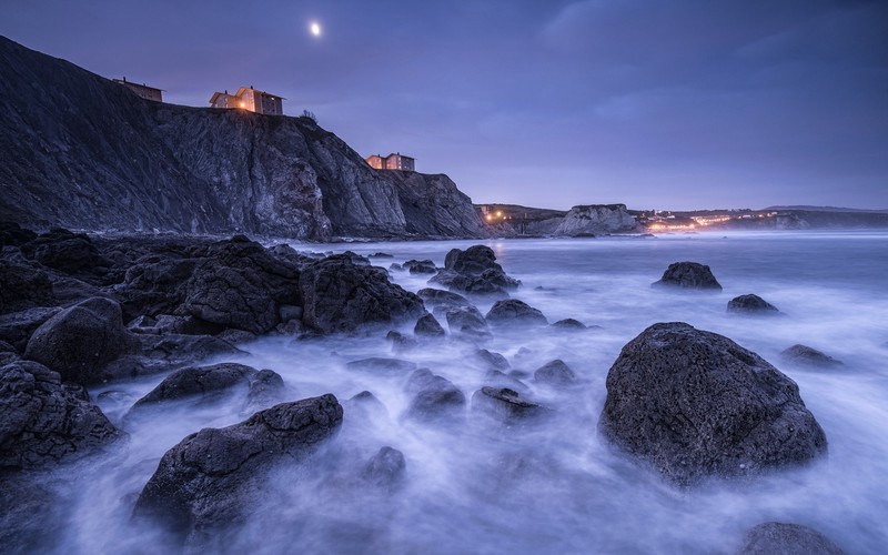 nature, sea, waves, landscape, cliff, Spain, coast, coastline, rock, stones, long exposure, evening, Moon, lights, building, house, city lights