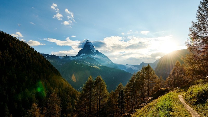 nature, landscape, mountains, clouds, trees, forest, plants, dirtroad, dirt road, sun rays, lens flare, paragliding, Switzerland, Swiss Alps