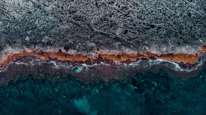 ocean, coast, aerial view, water, stones, surface, ribbed, 4k