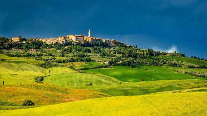 fields, dark sky, hill, town