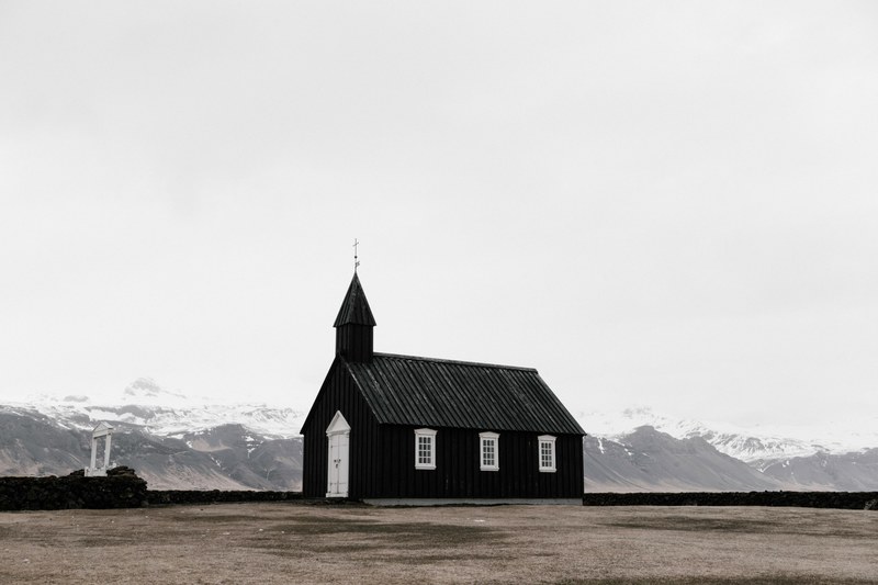 a small chapel in a plain with snowy mountains on the horizon, budir 4k
