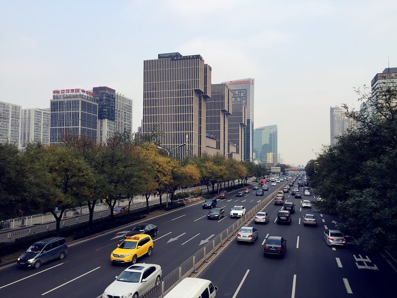 urban highway with skyscrapers and busy traffic during the day in guomao, busy daytime traffic in guomao 4k