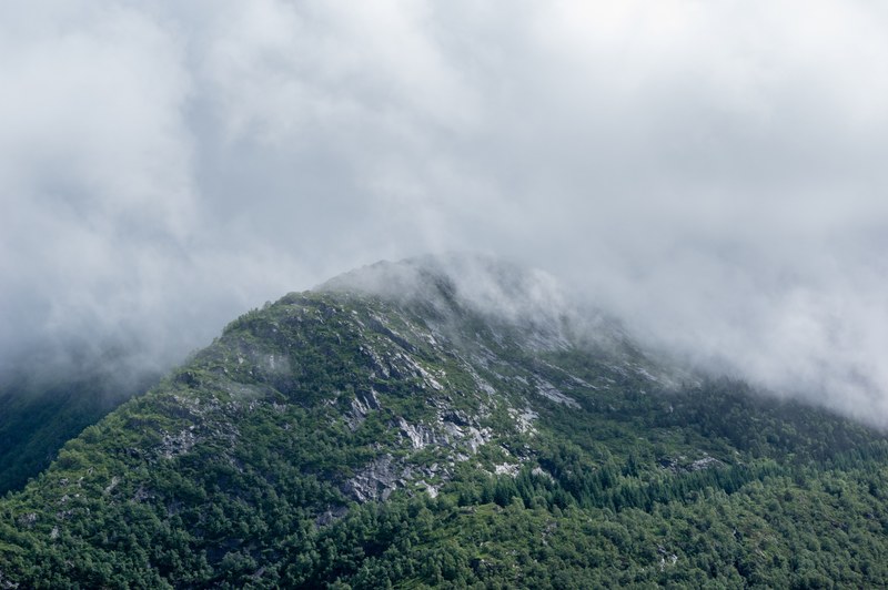 fog setting on a rugged mountain ridge in bergen, fog shrouded mountain ridge 4k