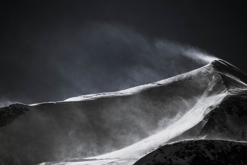 black and white drone shot of a mountain peak covered in snow, mountain peak in snow 4k