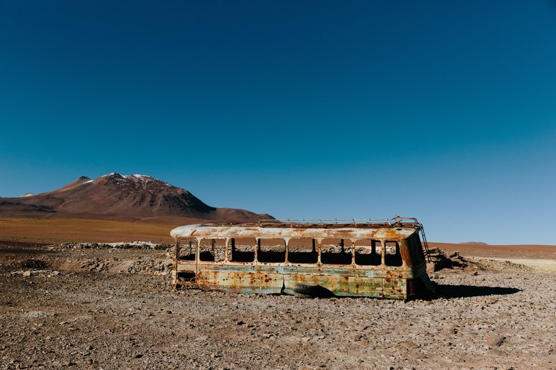 abandoned bus wreckage in the desert terrain of san pedro de atacama, abandoned school bus 4k