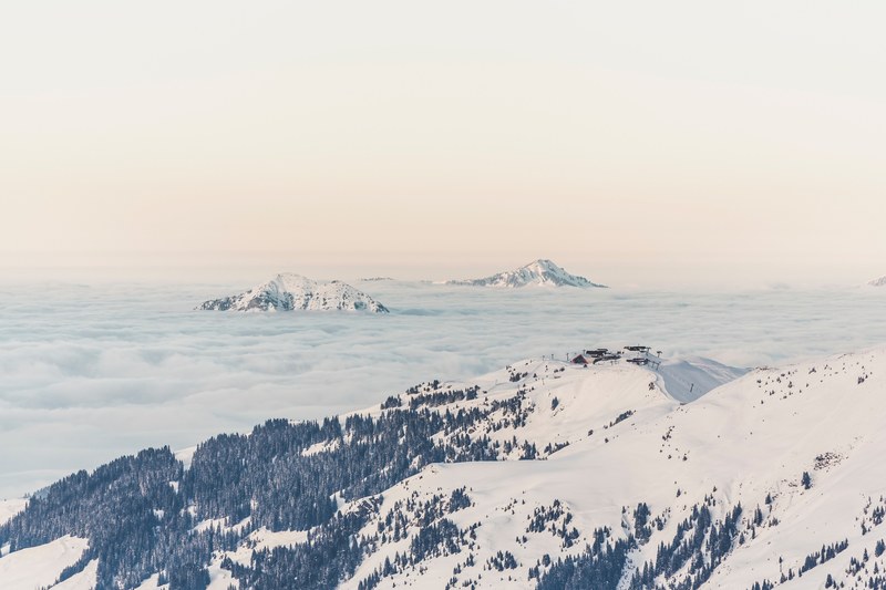 view of snowy mountain peaks of the kitzbhel alps amongst the clouds from the hahnenkammbahn cable car, kitzbhel from the hahnenkammbahn 4k