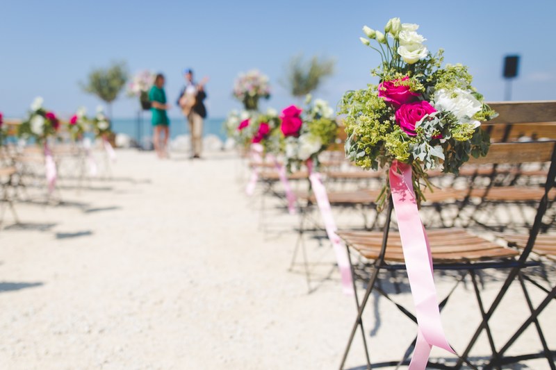 a beachfront wedding is being set up while a musician does a soundcheck, beach i do 4k