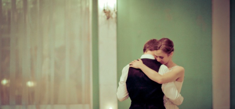 bride and groom dance quietly together in a green painted room, green room after reception 4k