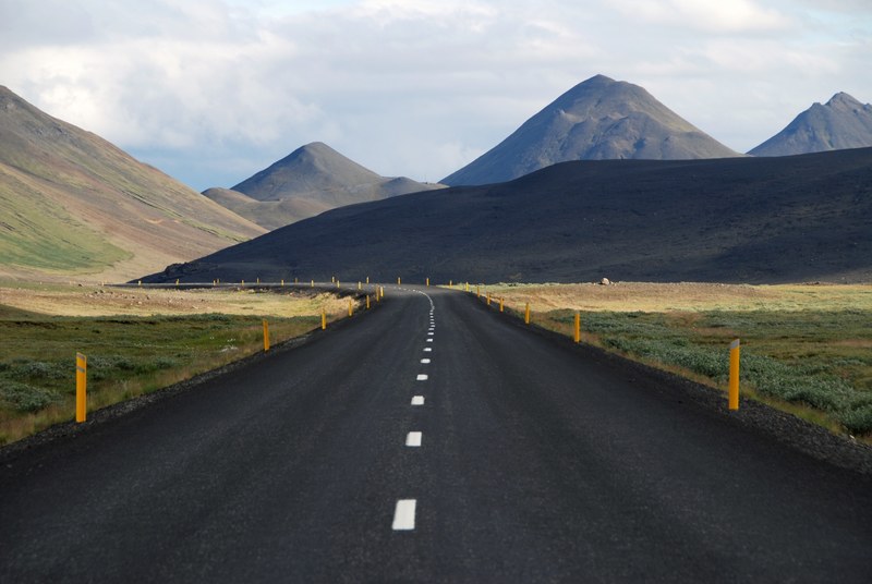 a curve in an empty asphalt road in the highlands, asphalt road under the hills 4k