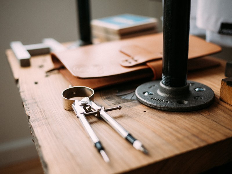 a workbench with a compass binder and tools on top, workbench and tools 4k