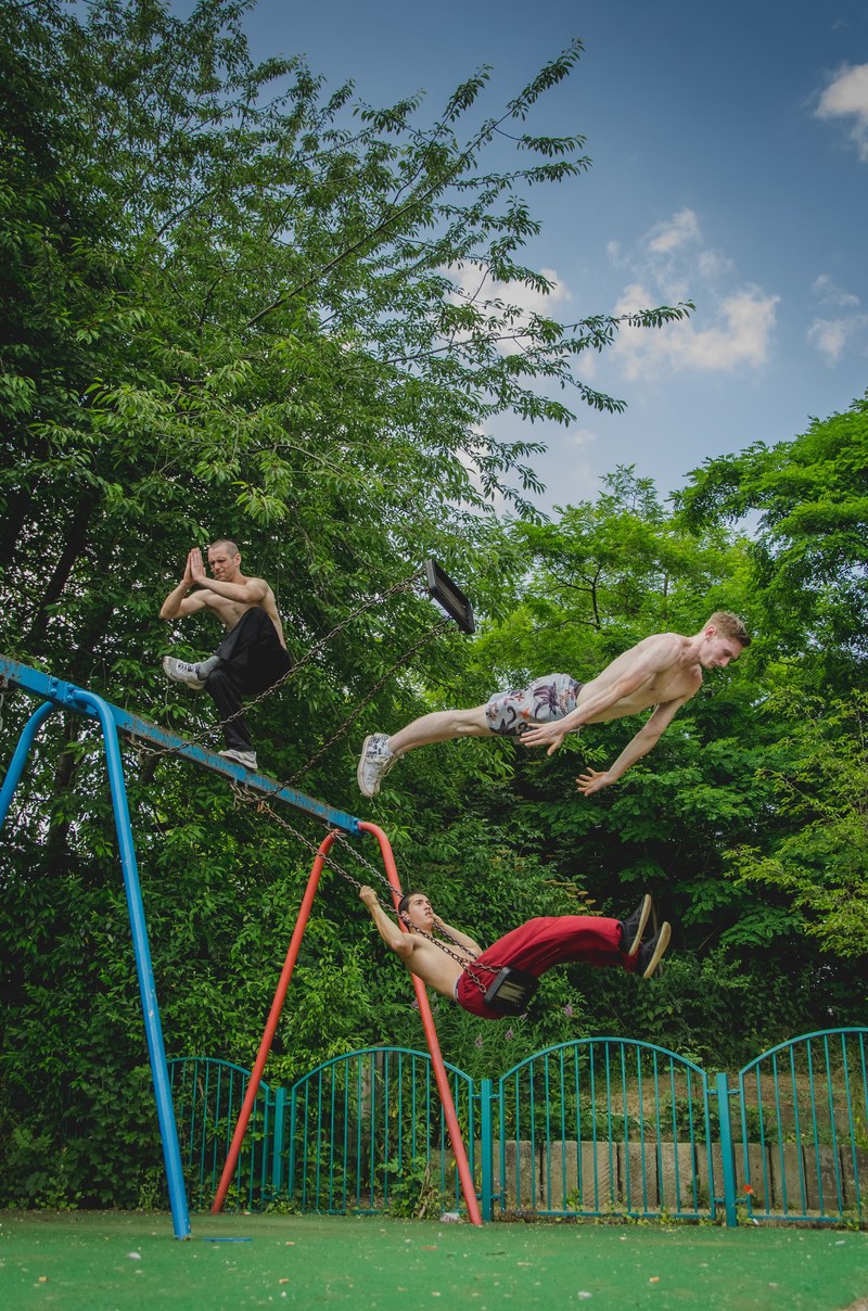 older boys meditating and jumping off a swing set, _swingset tricks 4k