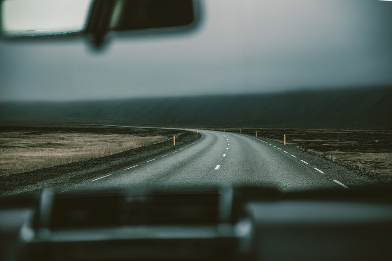 view from a cars front window on a curve in an empty road, hes got drive 4k