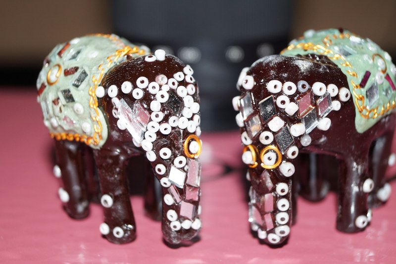 two small wooden elephant toys 4k