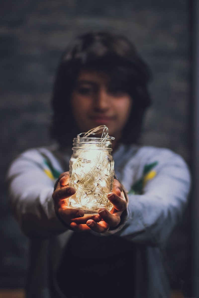 a person holding a mason jar of fairy lights in manipal university jaipur, manipal university jaipur 4k