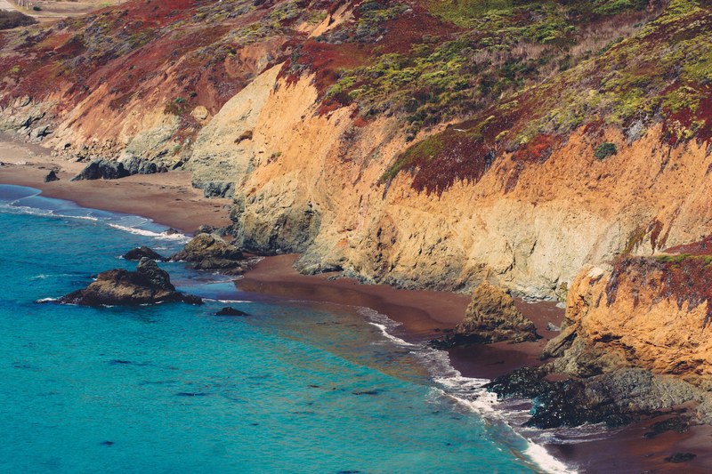 a deserted beach turquoise sea and rocky cliffs form a surfers paradise at marin headlands, surfers paradise 4k
