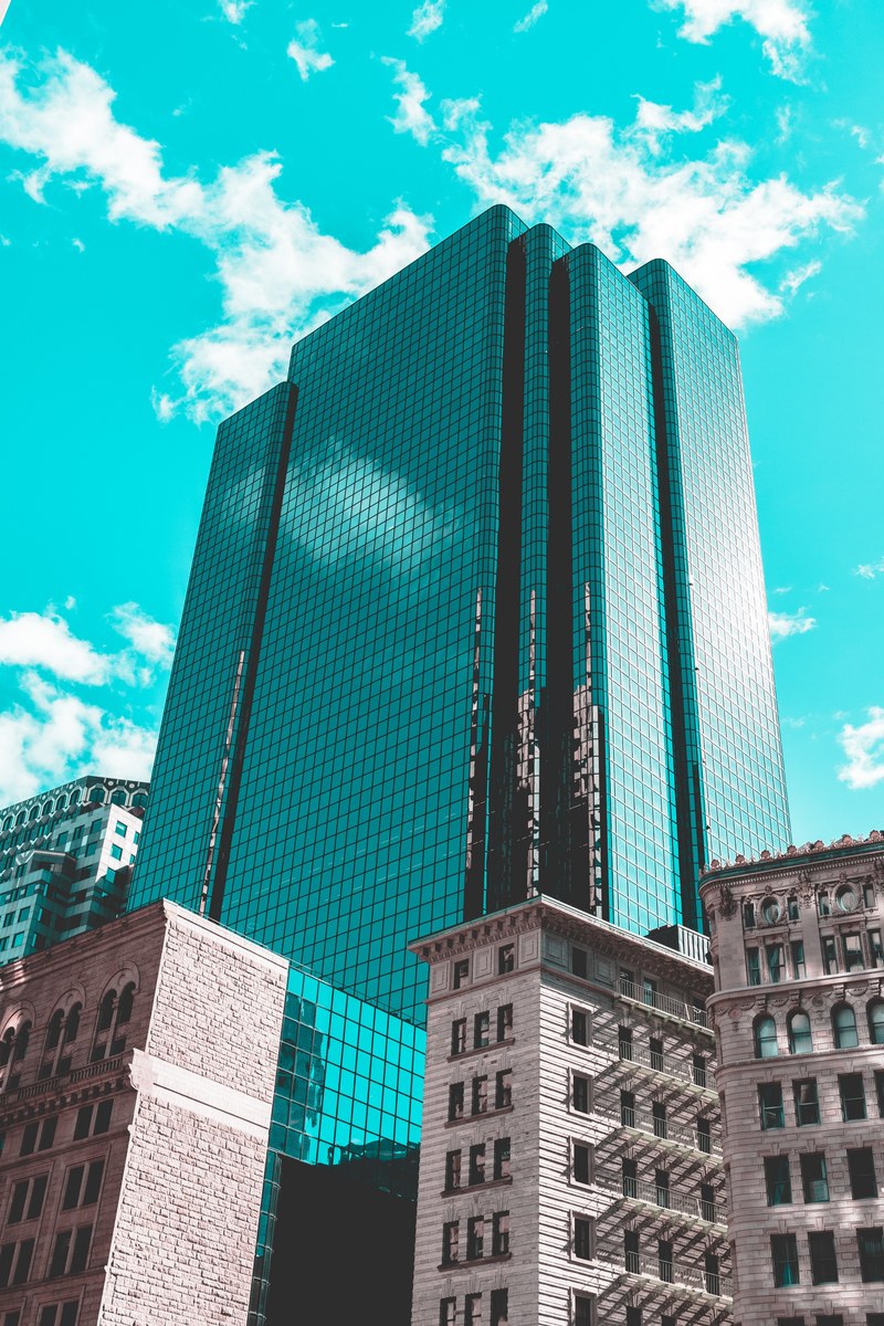 turquoise sky frames a reflective downtown office building, windows in the sky 4k