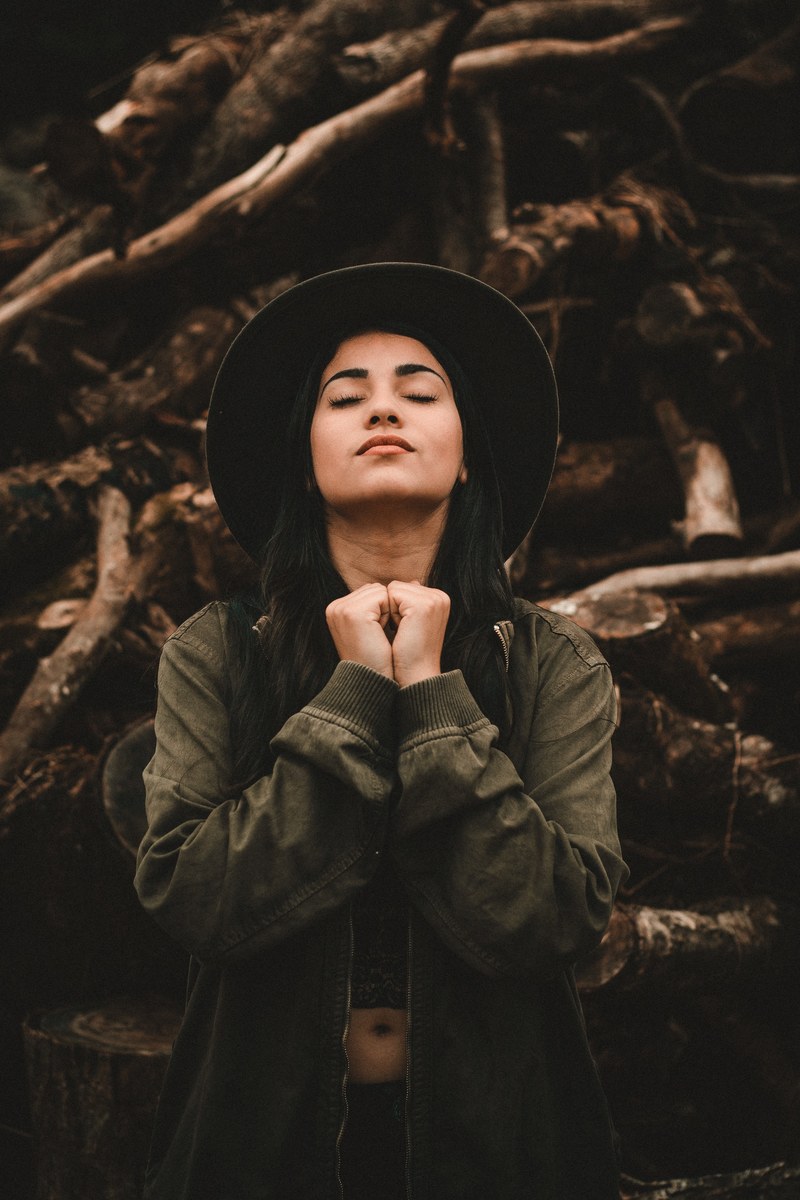woman wearing a hat hopefully holding her hands and praying, hoping and praying 4k