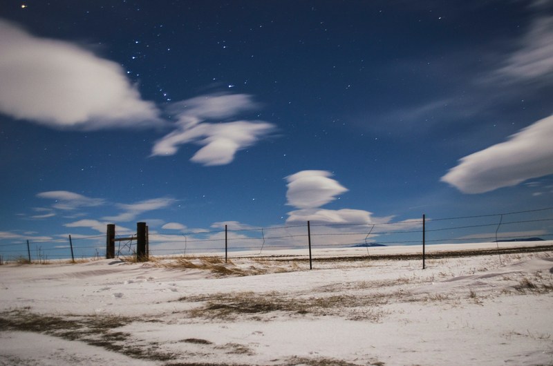 view of the cloudy star speckled sky at a fence near great falls, quiet 4k