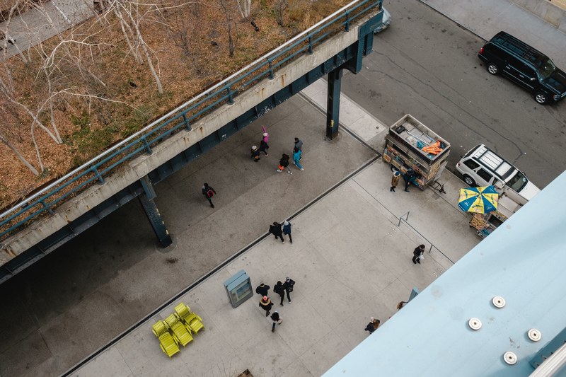 looking down from the rooftop of whitney museum of american art at people crossing the square, square whitney museum of american art 4k
