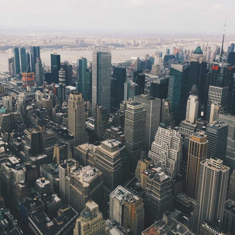 aerial drone shot of a downtown cityscape on a foggy day, urban skyline 4k